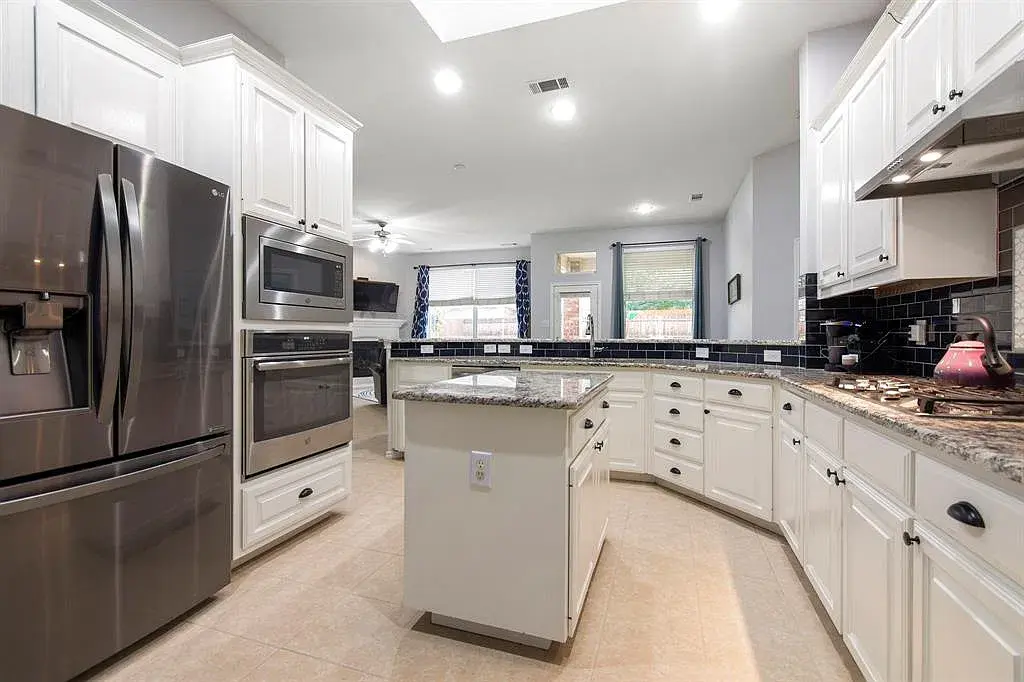Kitchen with island, stainless appliances, and granite countertops